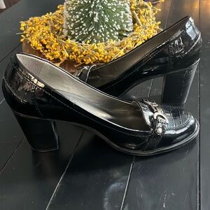 Black patent leather Bandolino loafers with a 2 inch heal. Worn decent condition